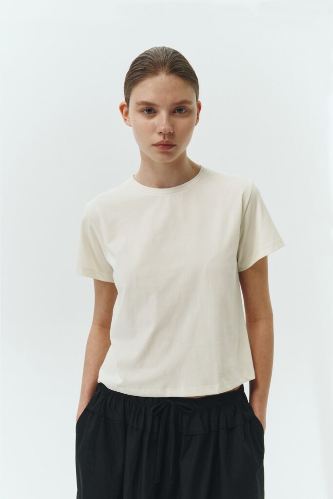 Ivy T-shirt in ivory, cropped short-sleeve tee in a lightweight cotton-poly blend with crew neck, regular fit, and clean silhouette.