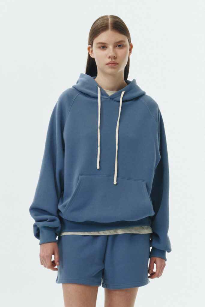 Kaia Hoodie in indigo blue, oversized cotton French terry pullover with drawstring hood, raglan sleeves, kangaroo pocket, and ribbed trims.
