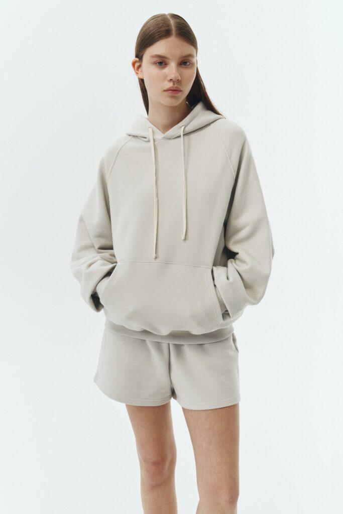 Kaia Hoodie in dune, oversized cotton French terry pullover with drawstring hood, raglan sleeves, kangaroo pocket, and ribbed trims.