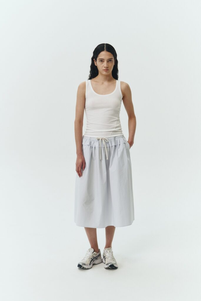Maryam Skirt in sky, a midi cotton skirt with shirred waistband, drawstring detail, side pockets, and a softly flared silhouette