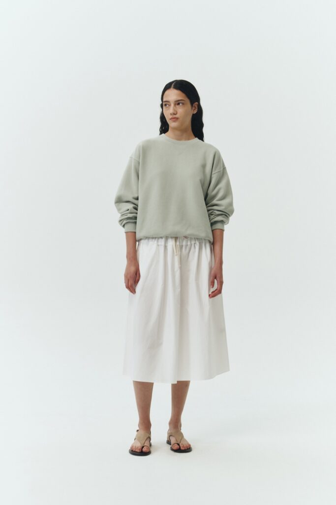 Maryam Skirt in sky, a midi cotton skirt with shirred waistband, drawstring detail, side pockets, and a softly flared silhouette