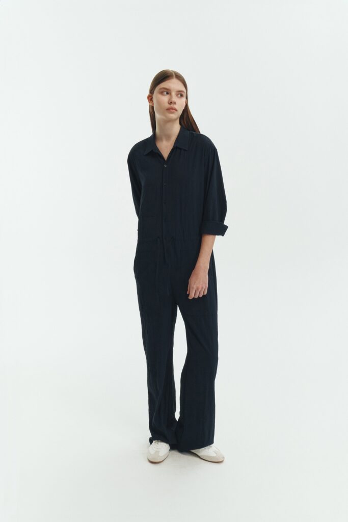 Saige Jumpsuit in navy, long-sleeve rayon blend jumpsuit with point collar, front button closure, drawstring waist, and patch pockets