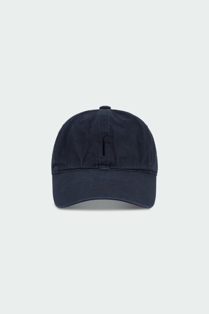Steva Oxford Cap in navy, made from soft washed cotton with a front embroidered logo and adjustable buckle strap, designed for a casual everyday look