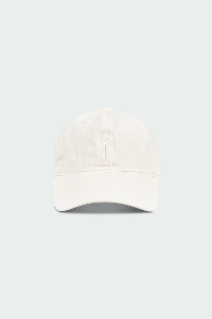 Steva Oxford Cap in cream, made from soft washed cotton with a front embroidered logo and adjustable buckle strap, designed for a casual everyday look