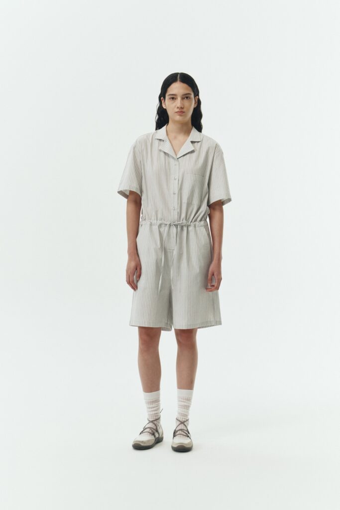 Emma Jumpsuit in stripe, short-sleeve cotton jumpsuit with camp collar, front buttons, drawstring waist, and multiple pockets.