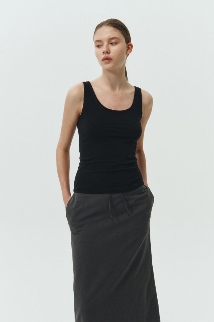 Zoe Tank Top in black, slim-fit stretch cotton tank with scooped neckline and diagonal seam detail for a sleek and minimal silhouette.